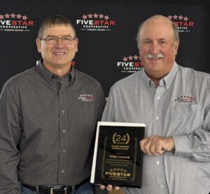 Terry Thomas holding plaque with Tom Shatek