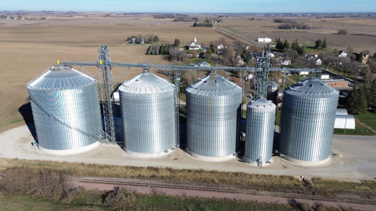 Five Grain Bins by train tracks in Scarville, Iowa